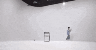 a blurry picture of a person running in a room with chinese writing .