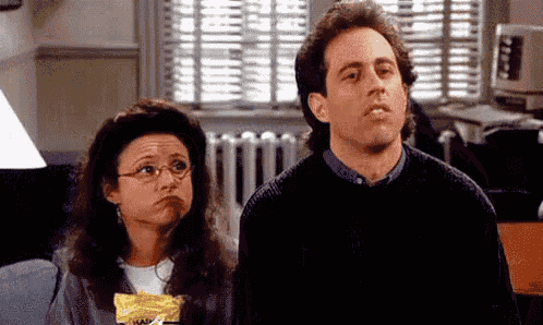 a man and a woman are standing next to each other in a room .