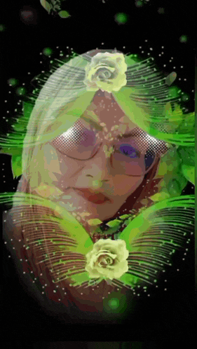 a woman 's face is surrounded by green flowers