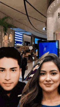 a man and a woman are posing for a picture in front of a store that says monkl