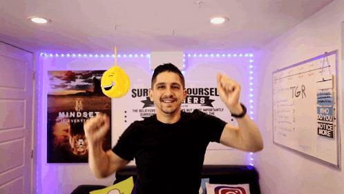 a man is dancing in front of a poster that says mindset