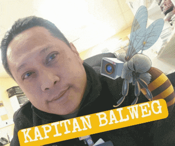 a man with a bee on his head and a yellow sign that says kaptan balweg
