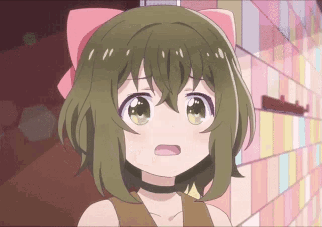 a little girl with green hair and a pink bow on her head
