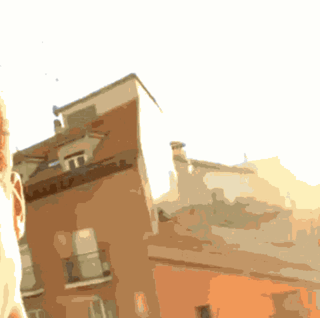 a person standing in front of a building with the sun shining through the windows