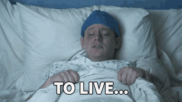 a man in a hospital gown is laying in bed with the words to live above him