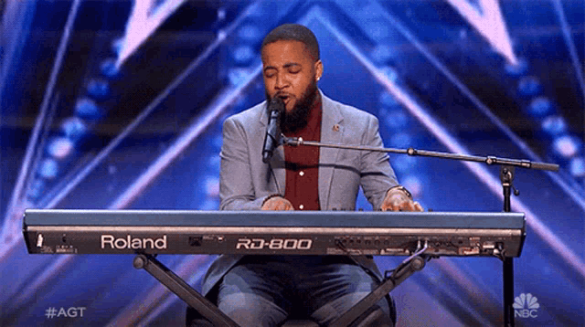 a man singing into a roland rd 800 keyboard