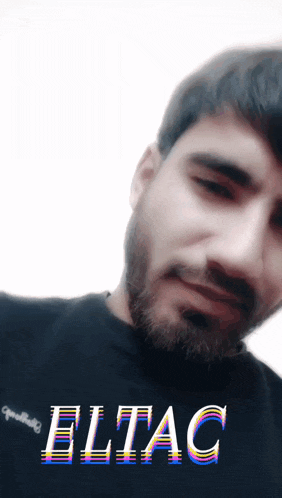 a man with a beard is wearing a black shirt with the word eltac on it