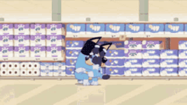 a dog is standing in front of a shelf of diapers