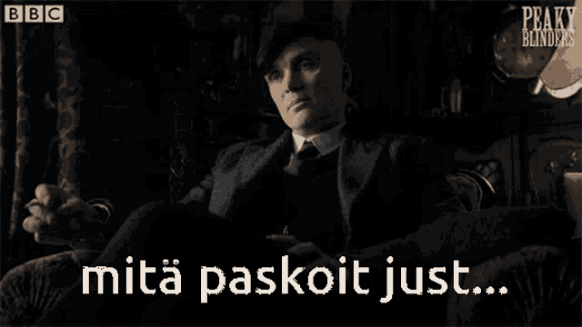 a bbc advertisement for peaky blinders shows a man in a suit looking out a window