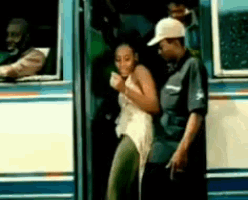a man and a woman are getting on a bus together