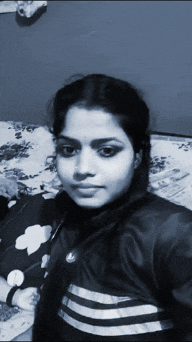 a black and white photo of a woman wearing a adidas jacket