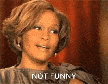 a woman in a dress is making a funny face and saying not funny .