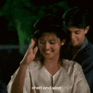 a man and a woman are standing next to each other .