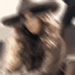 a blurry picture of a woman with long hair wearing a hat