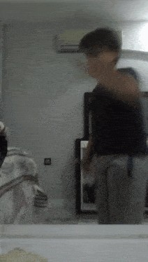 a blurry picture of a person standing in front of a mirror in a bedroom