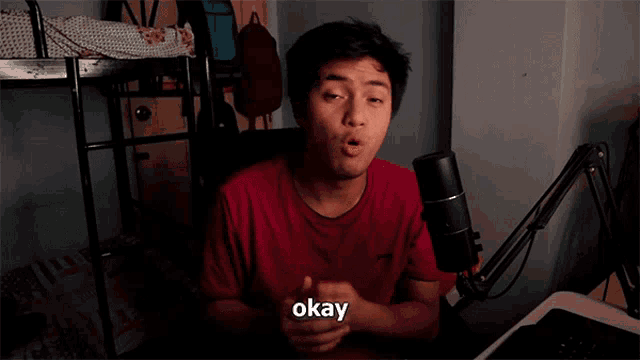 a young man in a red shirt says okay