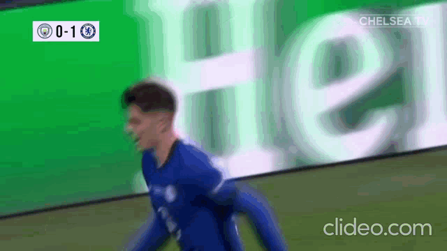 a soccer player is celebrating a goal in front of a heineken ad .