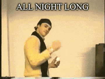 a man in a yellow sweater and black scarf is holding a remote control and says all night long .