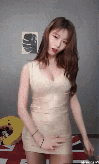 a woman in a white dress is dancing on a bed