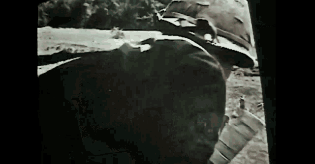 a black and white photo of a man with a bandaged arm