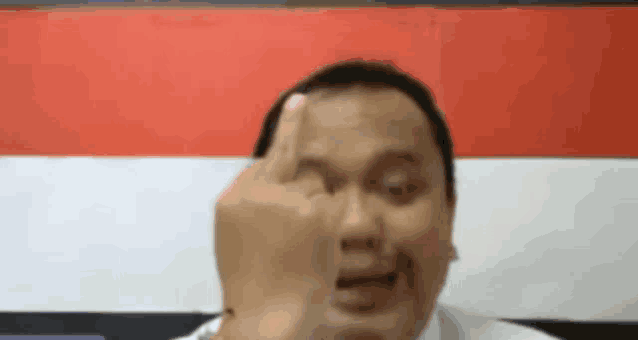 a man is giving the middle finger to the camera .
