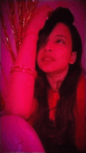 a woman 's face is visible in a red background