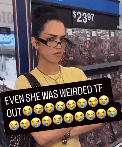 a woman wearing glasses is holding a sign that says even she was weirded tf out