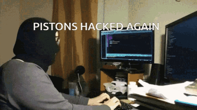 a man wearing a mask is typing on a keyboard with the words pistons hacked again written above him
