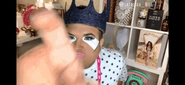 a man wearing a crown and a shirt with stars