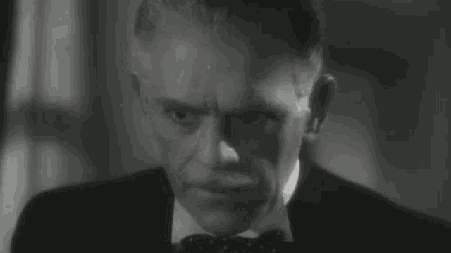a black and white photo of a man in a tuxedo