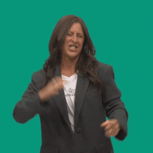 a woman wearing a blazer and a white shirt that says " we ever "