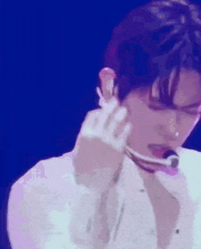 a close up of a person 's face with a microphone in their ear .