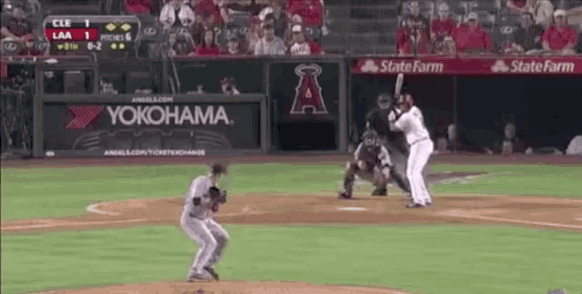 a baseball game is being played on a field with a yokohama ad in the outfield