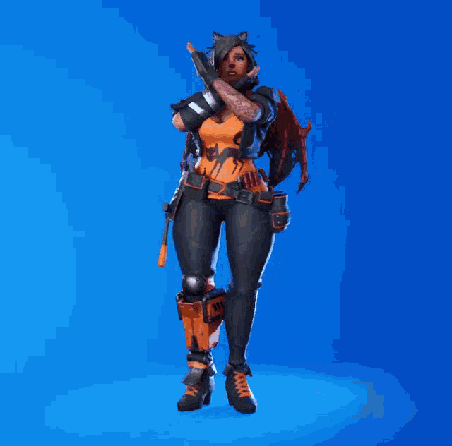 a woman in a black and orange outfit is dancing