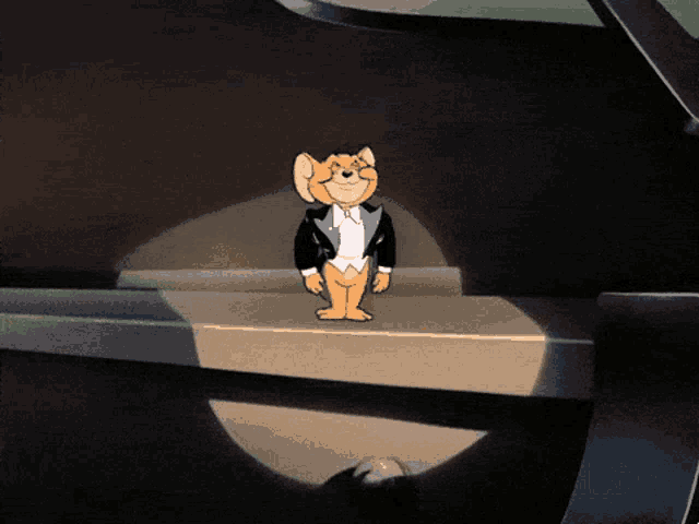 a cartoon mouse wearing a tuxedo is standing on a ledge