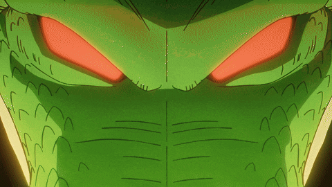 a close up of a green cartoon character with red eyes