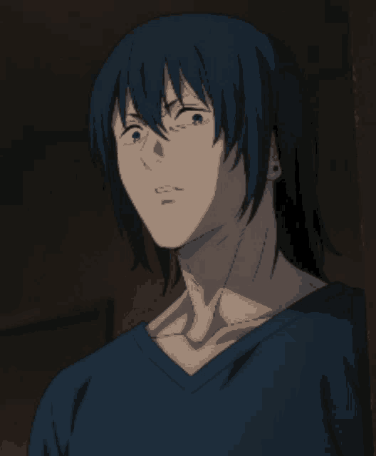 a close up of a person 's face with a blue shirt on