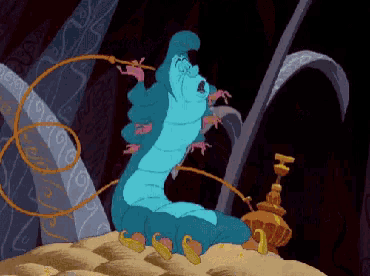 a blue caterpillar from alice in wonderland sits on a pile of sand