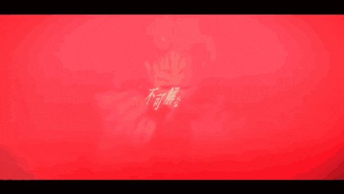 a man is holding a gun in his hands in a dark room .