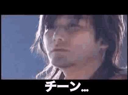 a close up of a man 's face with a foreign language written on it .