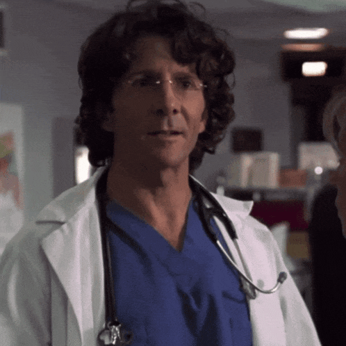 a man in a lab coat with a stethoscope around his neck is wearing glasses