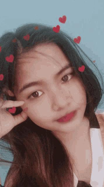 a girl with hearts on her hair is taking a picture