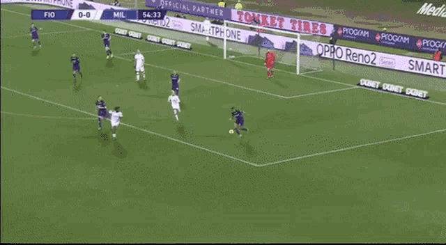 a soccer player in a purple jersey is kicking a yellow ball