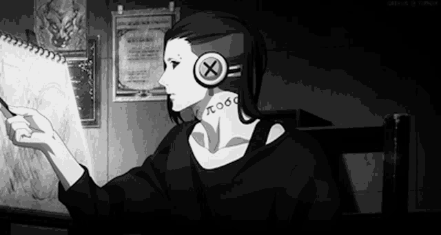 a black and white photo of a person wearing headphones and looking at a piece of paper .