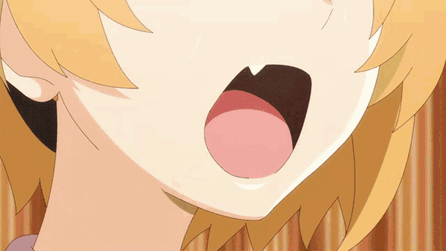 a close up of a girl 's mouth with her tongue hanging out
