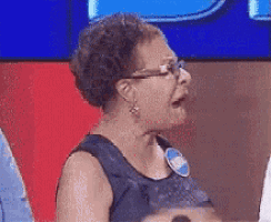 an older woman wearing glasses and a name tag that says ' sally ' on it