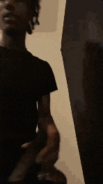 a man is holding a flashlight in his hand and pointing it at the camera .