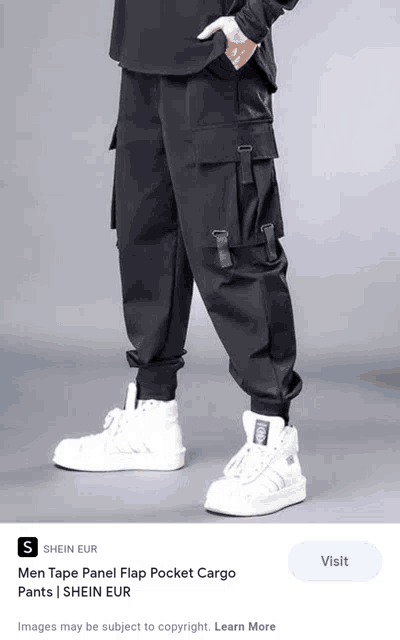a person wearing a pair of black cargo pants and white sneakers