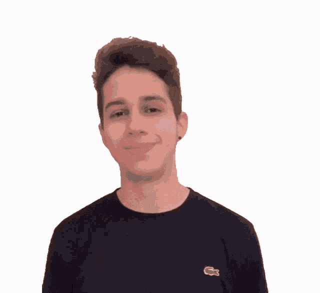 a man wearing a black shirt with a lacoste logo on the left side of his chest