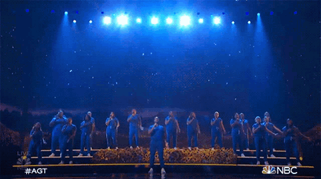a group of people on a stage with nbc written on the bottom right